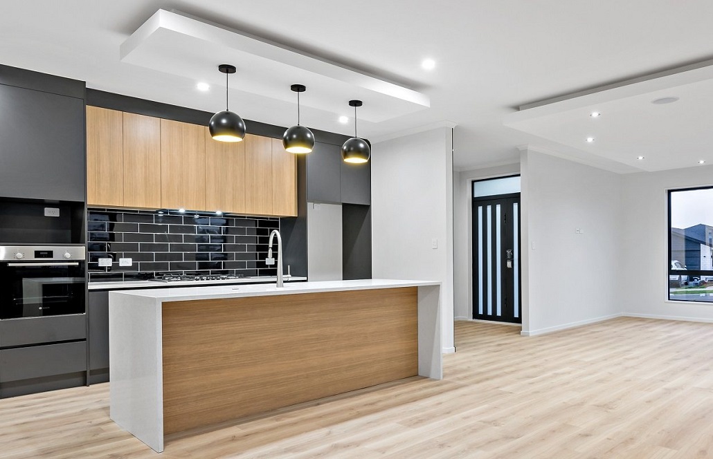 Open plan living space with new kitchen by best home builders Auckland